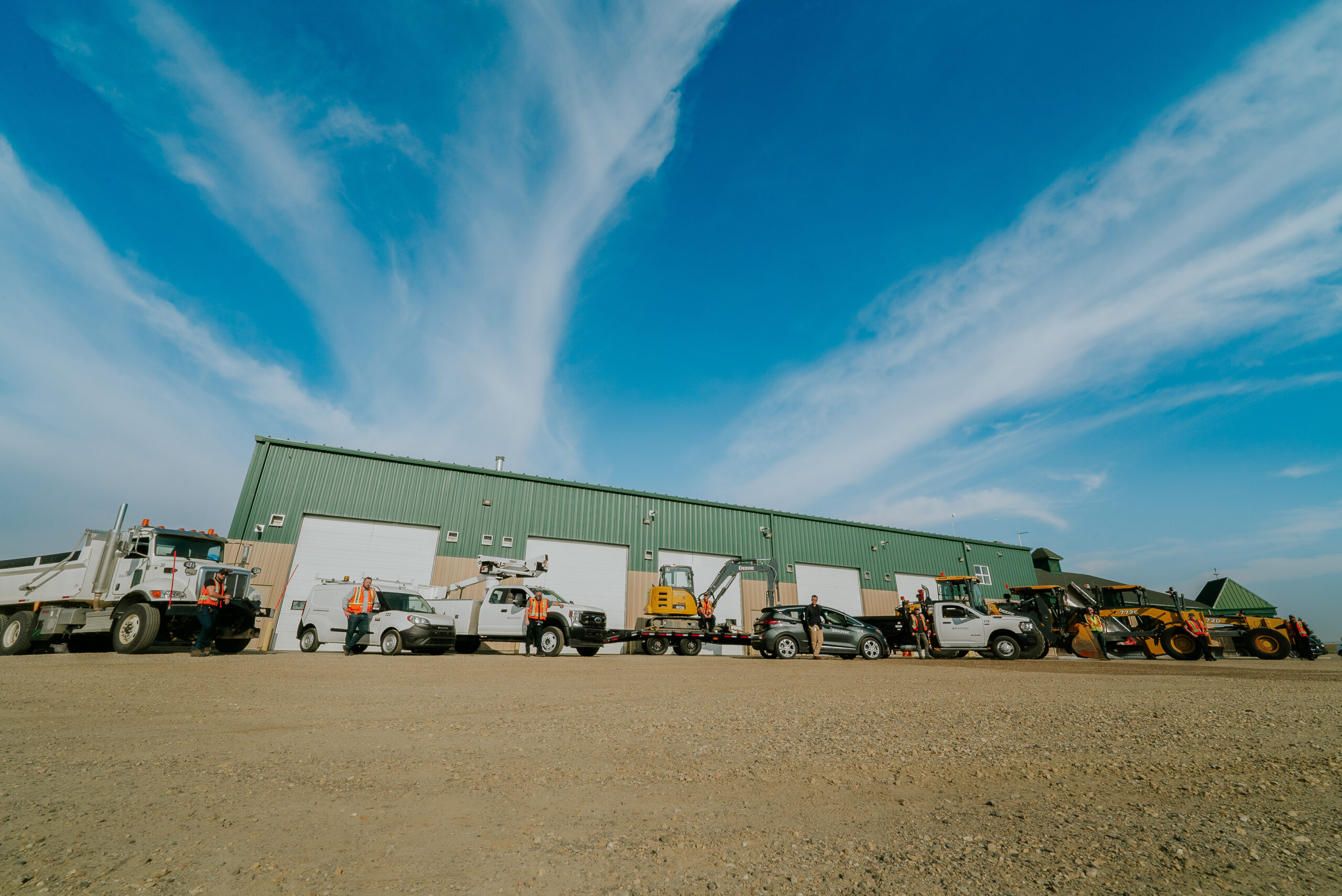 The Beaumont Operations Facility building. A large structure with a bunch of vehicles and equipment parked in front.