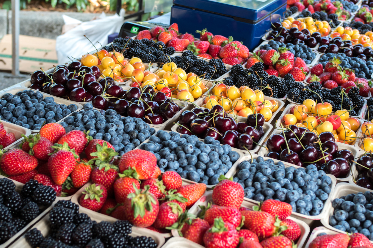 Organic Fresh Berries Photo of fresh berries and cherries in berry baskets displayed in rows at a farmers market